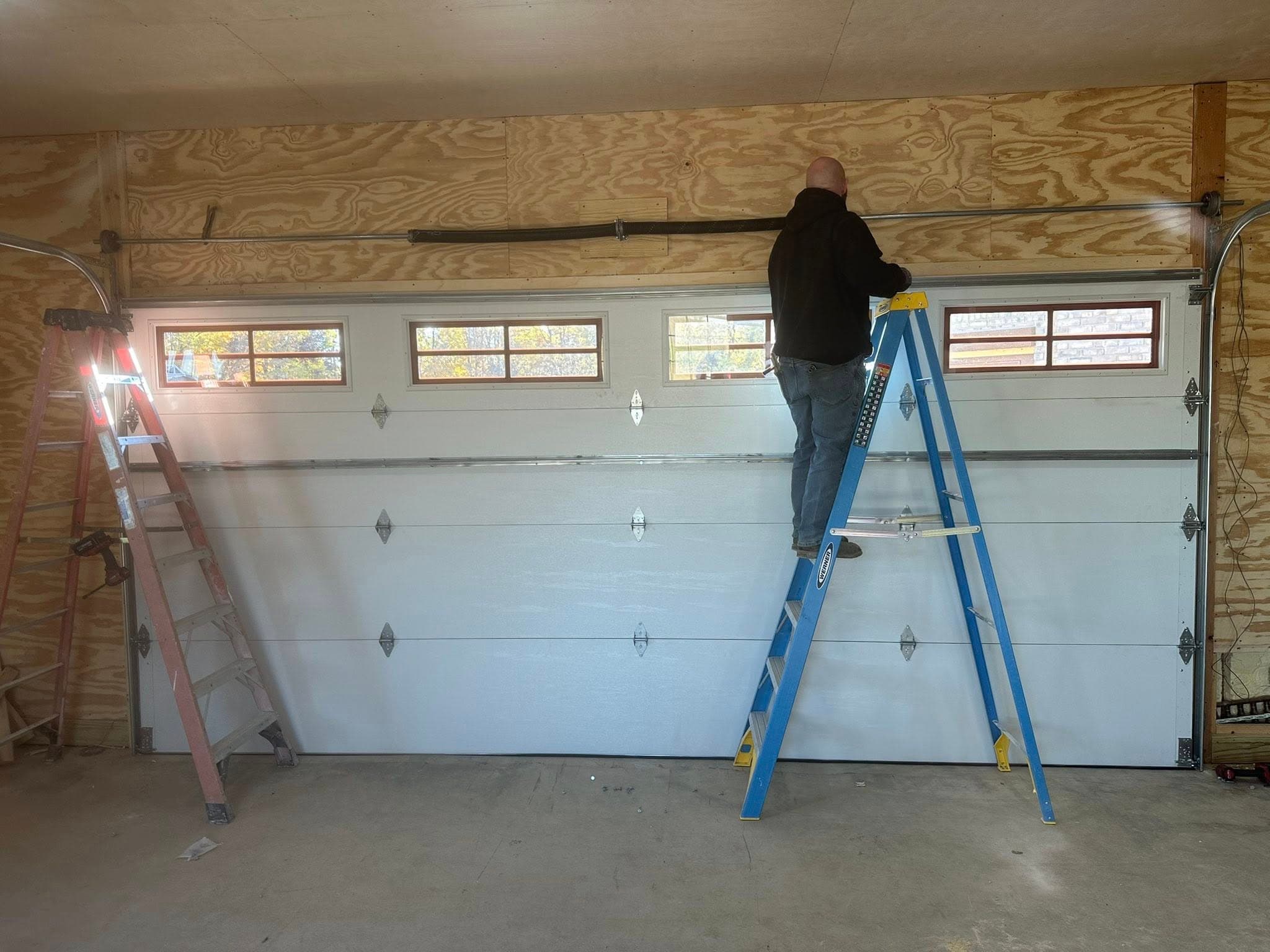Barnett's Garage Doors actively installing a customer's garage door.
